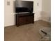 Living room with a dark wood TV stand and contemporary glass side tables at 13116 Erwin Rd, Charlotte, NC 28273
