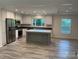 Modern kitchen with stainless steel appliances, a center island, and ample natural light at 138 Zircon Dr, Statesville, NC 28625