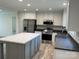 Bright kitchen featuring stainless steel appliances, custom cabinets, and a center island at 138 Zircon Dr, Statesville, NC 28625