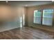 Living room featuring light-colored walls, and wood-look flooring, and large windows at 138 Zircon Dr, Statesville, NC 28625