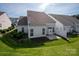 A sweeping aerial shot of a well-maintained backyard featuring lush grass and a private patio at 1498 Burrell Nw Ave, Concord, NC 28027
