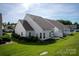 Aerial view of the property's backyard showcasing the green lawn, patio, and surrounding landscape at 1498 Burrell Nw Ave, Concord, NC 28027