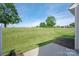 Backyard featuring well-maintained lawn and a view of the surrounding neighborhood at 1498 Burrell Nw Ave, Concord, NC 28027