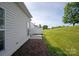 Side view of home showcasing the patio, lawn, and privacy fence, perfect for outdoor enjoyment at 1498 Burrell Nw Ave, Concord, NC 28027