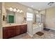 Bathroom featuring double sinks, large tub, and a separate glass shower at 1498 Burrell Nw Ave, Concord, NC 28027