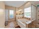 Bathroom featuring a soaking tub, separate glass shower, and a double vanity at 1498 Burrell Nw Ave, Concord, NC 28027