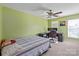 Bedroom with green walls, a ceiling fan, and a functional desk space near the window at 1498 Burrell Nw Ave, Concord, NC 28027