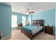 A cozy bedroom featuring a wooden bed frame and a well-lit desk area near the bright windows at 1498 Burrell Nw Ave, Concord, NC 28027