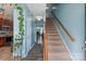 Inviting entryway featuring a staircase, wood-look flooring, and a glimpse of the living area at 1498 Burrell Nw Ave, Concord, NC 28027