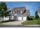 Charming two-story home featuring a brick facade, two-car garage, and well-manicured lawn at 1498 Burrell Nw Ave, Concord, NC 28027