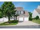 Charming two-story home featuring a brick facade, two-car garage, and well-manicured lawn at 1498 Burrell Nw Ave, Concord, NC 28027
