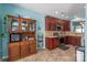 Traditional kitchen with wooden cabinetry, tile backsplash, and tile flooring with stainless appliances at 1498 Burrell Nw Ave, Concord, NC 28027