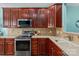 Well-equipped kitchen features stainless steel appliances, granite countertops, and wooden cabinets at 1498 Burrell Nw Ave, Concord, NC 28027