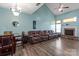 Spacious living room with vaulted ceiling, fireplace, wood floors, and comfortable seating at 1498 Burrell Nw Ave, Concord, NC 28027