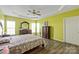 Relaxing main bedroom with a tray ceiling, fan, and neutral decor at 1498 Burrell Nw Ave, Concord, NC 28027
