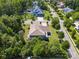Aerial view of large home with wooden deck surrounded by mature trees in a quiet neighborhood at 16547 Bastille Dr, Charlotte, NC 28278