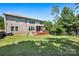 Spacious backyard with brick home, deck, outdoor grill and manicured lawn at 16547 Bastille Dr, Charlotte, NC 28278