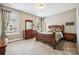 This bedroom features a standard closet, plenty of natural light, and carpeted floors at 16547 Bastille Dr, Charlotte, NC 28278