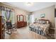 This bedroom features floral curtains, a wooden dresser and a comfortable rocking chair at 16547 Bastille Dr, Charlotte, NC 28278