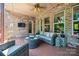 Comfortable covered deck with seating area, ceiling fan, and outdoor TV at 16547 Bastille Dr, Charlotte, NC 28278