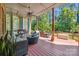 Spacious covered deck with outdoor seating and view of the lush backyard at 16547 Bastille Dr, Charlotte, NC 28278