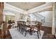 Elegant dining area featuring a large table, hardwood floors, and seamless flow to the living spaces at 16547 Bastille Dr, Charlotte, NC 28278