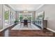 Elegant dining room featuring hardwood floors, a modern chandelier, and large windows at 16547 Bastille Dr, Charlotte, NC 28278