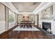 Formal dining room with tray ceiling, a fireplace, large windows and hardwood floors at 16547 Bastille Dr, Charlotte, NC 28278