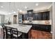 Kitchen featuring a granite island, stainless appliances, and dark cabinets at 16547 Bastille Dr, Charlotte, NC 28278