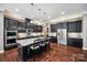 A gourmet kitchen with a large island, granite countertops, and stainless steel appliances at 16547 Bastille Dr, Charlotte, NC 28278