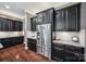This kitchen is equipped with stainless steel appliances, granite countertops, and dark cabinetry at 16547 Bastille Dr, Charlotte, NC 28278