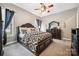 A nicely decorated main bedroom offers neutral colored walls and a ceiling fan at 16547 Bastille Dr, Charlotte, NC 28278