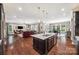 Expansive open-concept layout showcasing a modern kitchen, living area, and dining space, perfect for entertaining at 16547 Bastille Dr, Charlotte, NC 28278