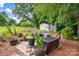Serene backyard patio featuring outdoor furniture, potted plants, and a charming storage shed at 169 Primrose Ln, Statesville, NC 28625