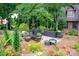 Inviting backyard patio with comfortable seating amidst lush greenery, perfect for outdoor relaxation at 169 Primrose Ln, Statesville, NC 28625