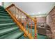 Finished basement features a staircase, brick accent wall and comfortable seating area at 169 Primrose Ln, Statesville, NC 28625