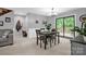 Bright dining area with neutral colors, chandelier, and sliding glass doors to deck at 169 Primrose Ln, Statesville, NC 28625