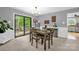 Open dining room featuring a wood table, modern chandelier, and deck access at 169 Primrose Ln, Statesville, NC 28625