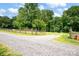 Long gravel driveway leading to a home provides ample parking space at 169 Primrose Ln, Statesville, NC 28625