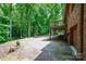 Brick home's expansive driveway leads to an attached garage and outdoor entertainment area at 169 Primrose Ln, Statesville, NC 28625