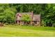 Well-maintained home showcasing a lush lawn and mature trees in a peaceful setting at 169 Primrose Ln, Statesville, NC 28625