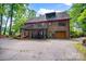 Brick home features a two-level wooden deck overlooking the backyard and attached garage at 169 Primrose Ln, Statesville, NC 28625