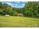 Expansive front yard with lush green grass and mature trees at 169 Primrose Ln, Statesville, NC 28625