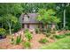 Charming brick home featuring dormers and a beautifully landscaped front yard with colorful flowers at 169 Primrose Ln, Statesville, NC 28625
