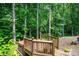 Wooden deck surrounds a hot tub in a private wooded setting at 169 Primrose Ln, Statesville, NC 28625