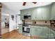 Modern kitchen with green cabinets, stainless steel appliances and wood floors at 169 Primrose Ln, Statesville, NC 28625