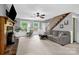 Comfortable living room with fireplace, staircase, and natural light at 169 Primrose Ln, Statesville, NC 28625