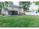 Large, well-maintained backyard with lush lawn, deck, and screened porch at 1699 Riverdale Dr, Rock Hill, SC 29732