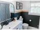 Stylish bathroom with black and white color scheme, modern fixtures, and decorative art at 1699 Riverdale Dr, Rock Hill, SC 29732