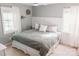 Bright bedroom featuring a bed with gray bedding, natural light and neutral décor for a cozy space at 1699 Riverdale Dr, Rock Hill, SC 29732